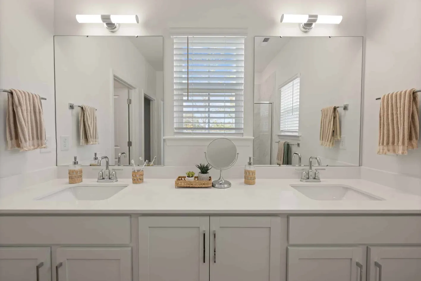 Double vanity bathroom with large mirrors