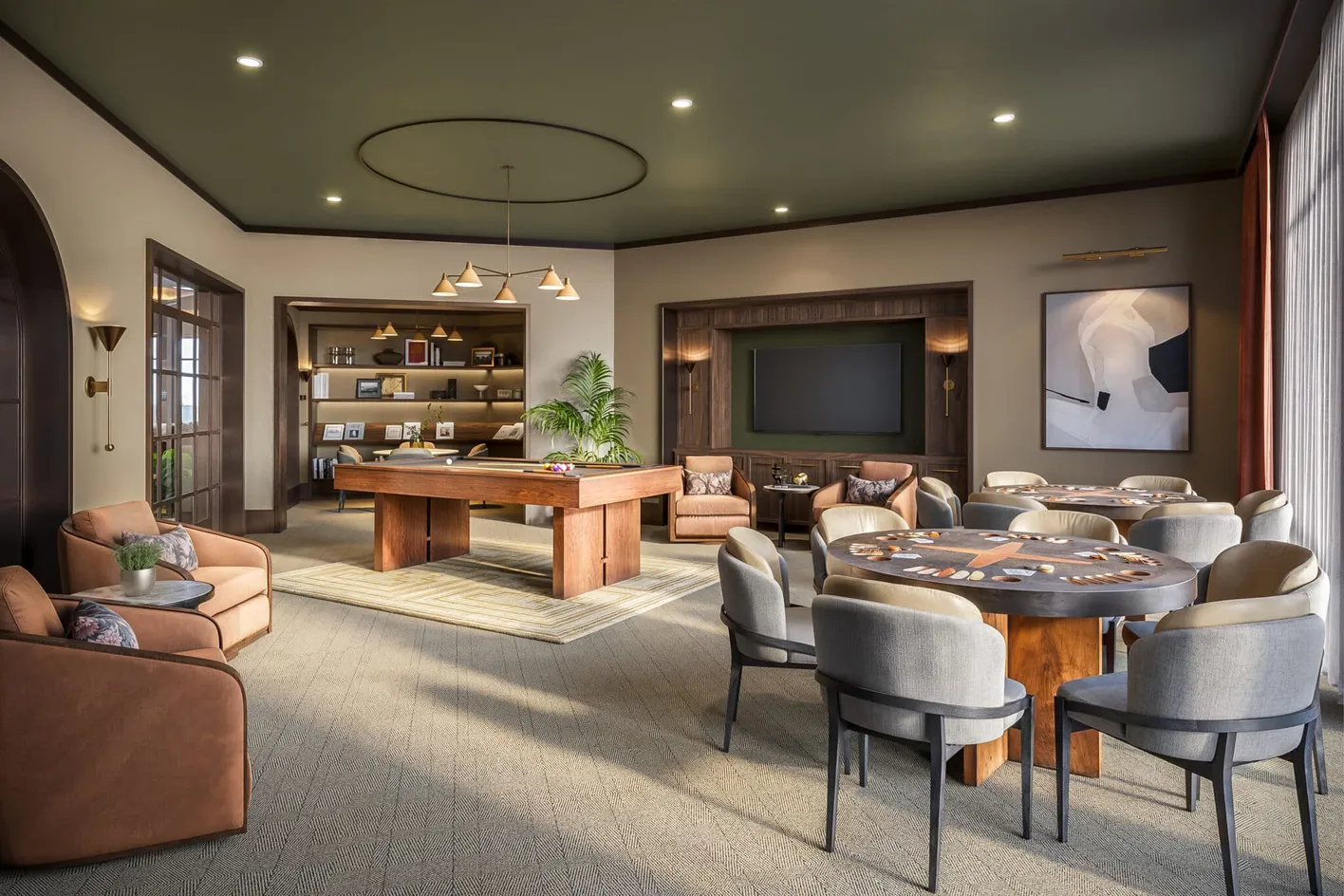 Resident game room and library lounge with billiards and card tables.