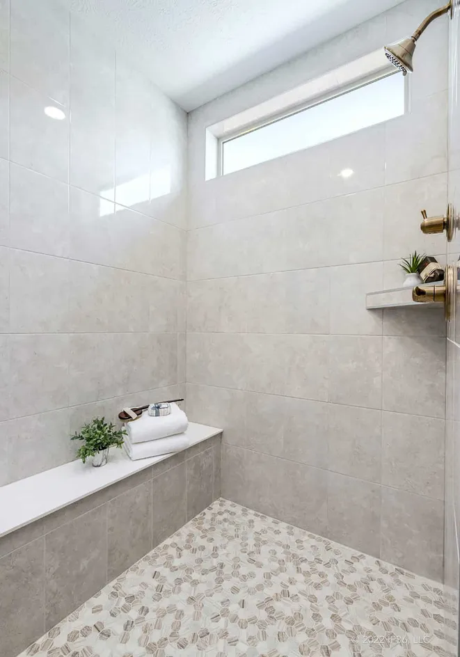 Walk-in tiled shower with bench seating