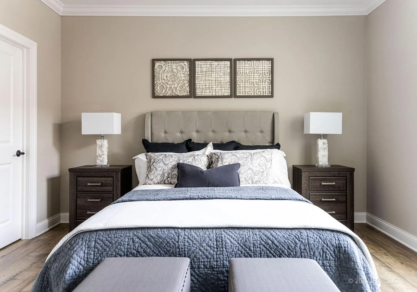 Primary bedroom with upholstered bed and decor