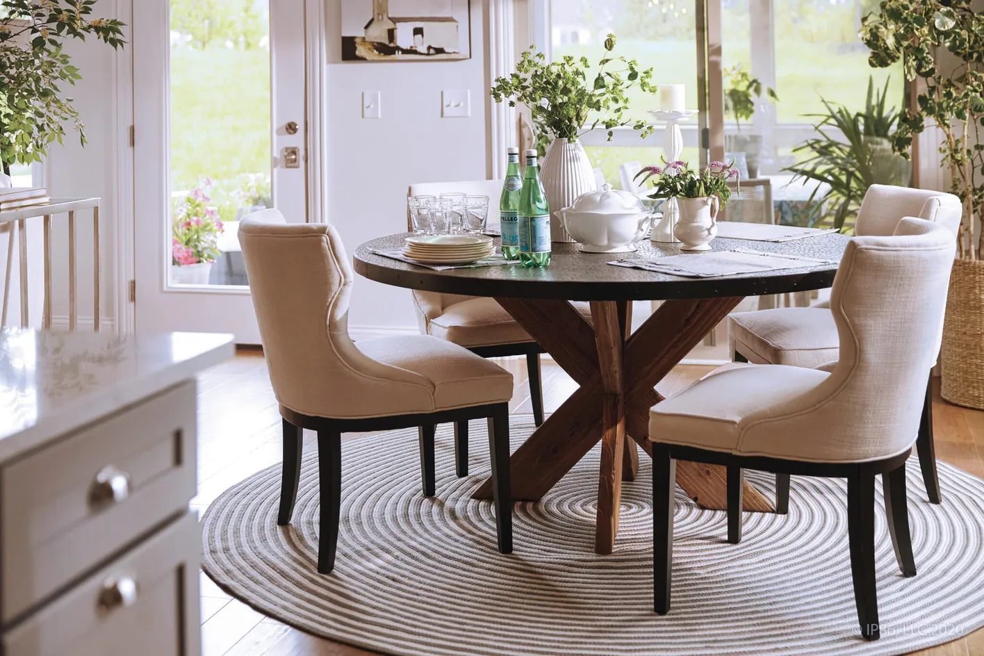 Dining area with round table and upholstered chairs