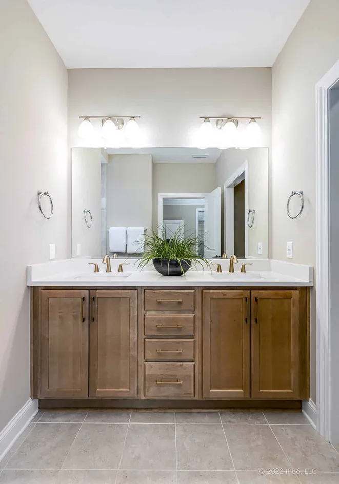 Bathroom with double vanity and lighting fixtures