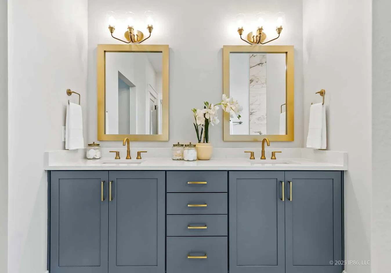 Dual vanity bathroom with gold accents