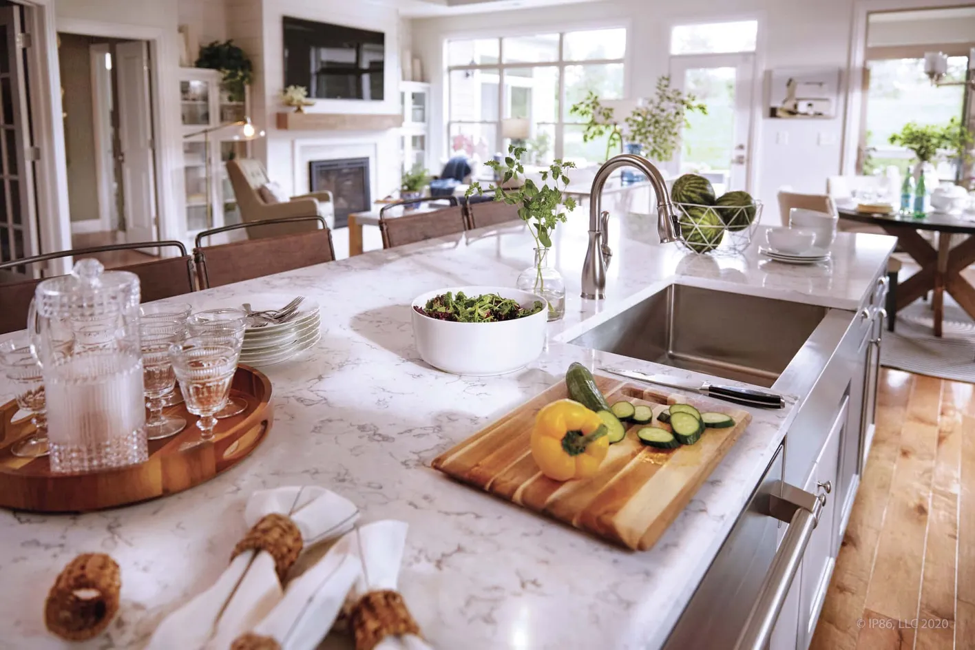 Bright kitchen island with quartz countertops and open living area