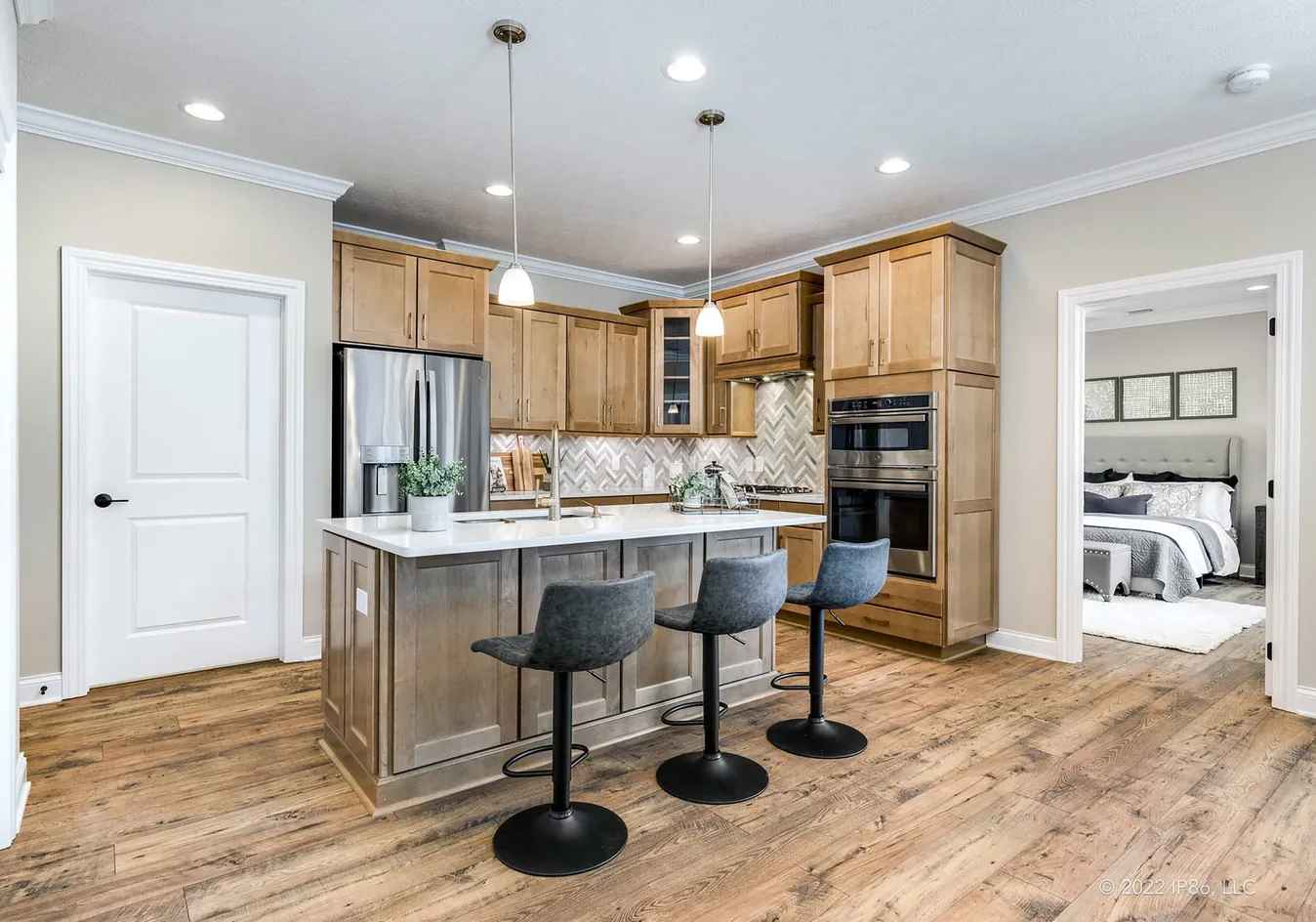 Kitchen with bar seating and adjacent bedroom entry