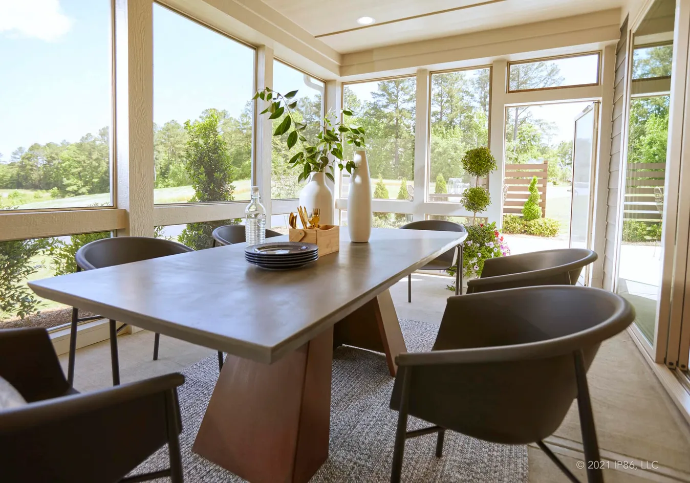 Light-filled sunroom offering a relaxing dining experience with outdoor views