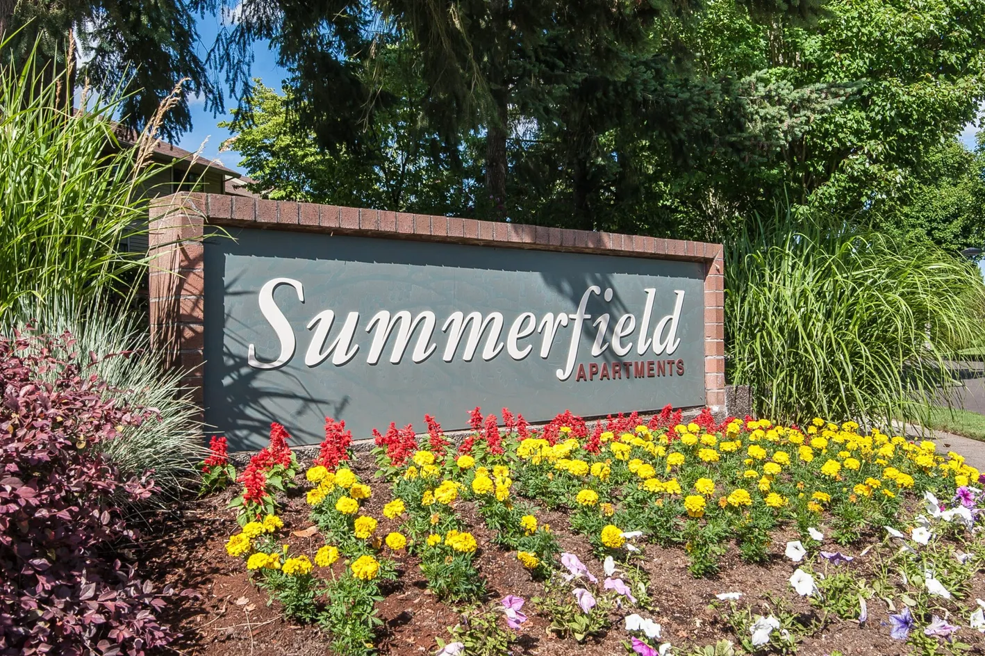 Community entrance sign with flowers