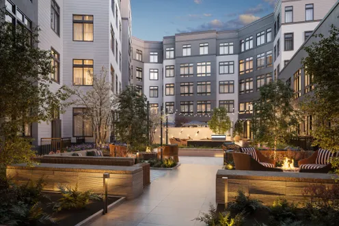 Landscaped courtyard with outdoor lounge seating and fire pit areas.
