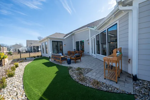 Curved turf yard beside patio