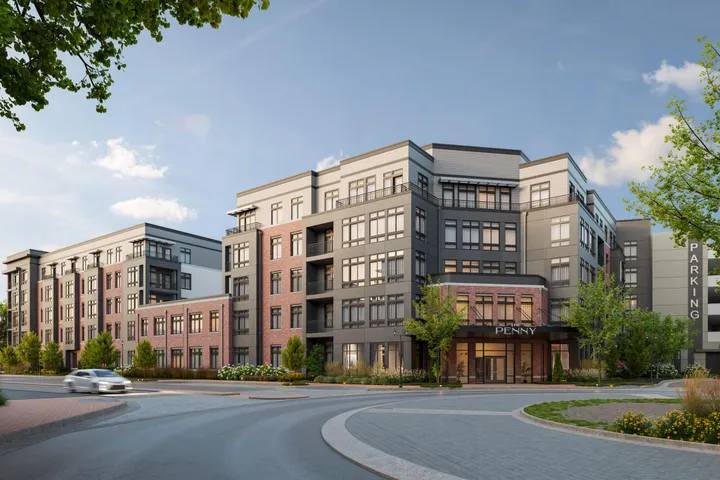 Exterior view of The Penny apartment community with modern architecture and covered entrance.