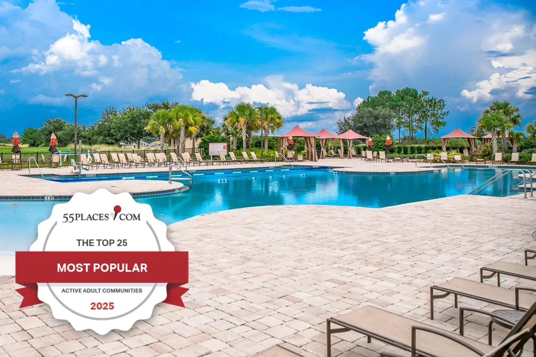 "The Top 25 Most Popular Active Adult Communities" badge over an outdoor pool at On Top of the World in Ocala, Florida.